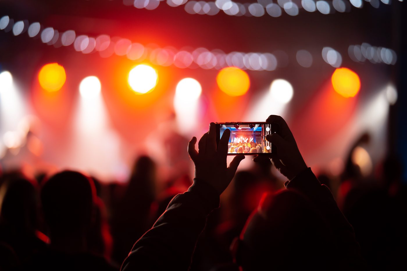 Crowd filming an event